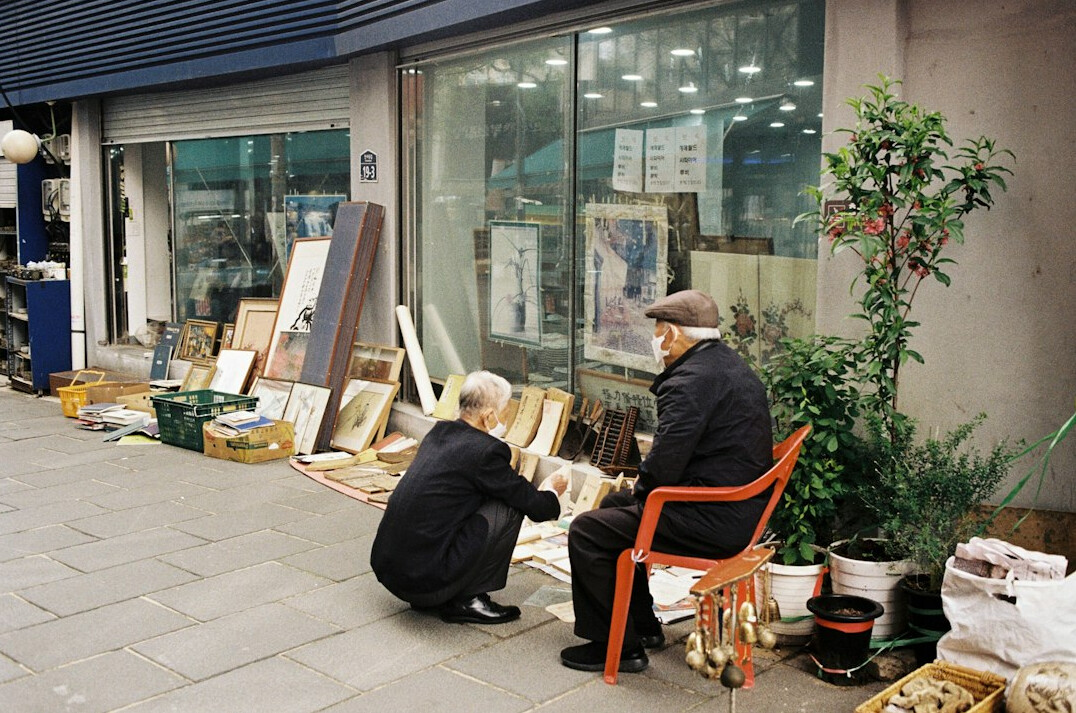 Financial consultant explaining documents to a senior client in a bright office