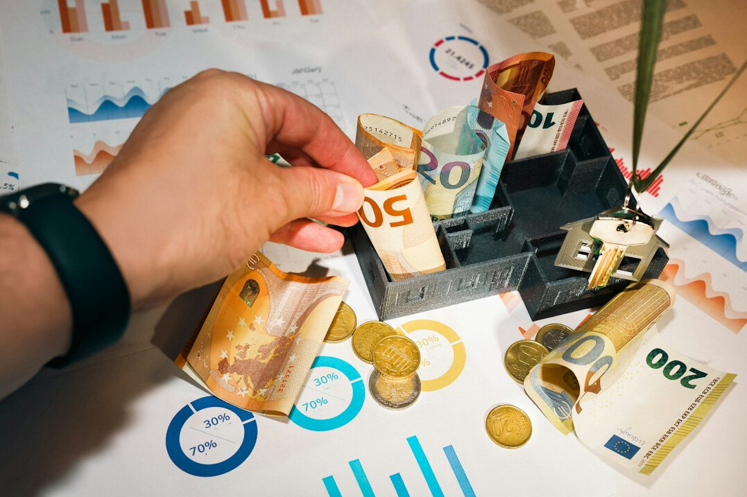 person counting coins and bills