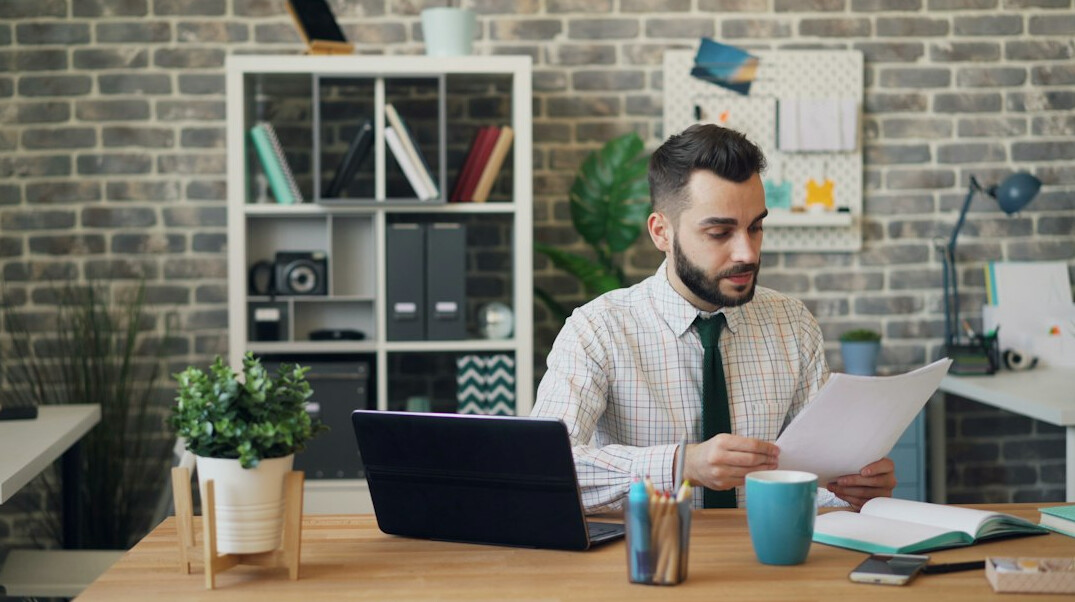 person reviewing budget papers at desk