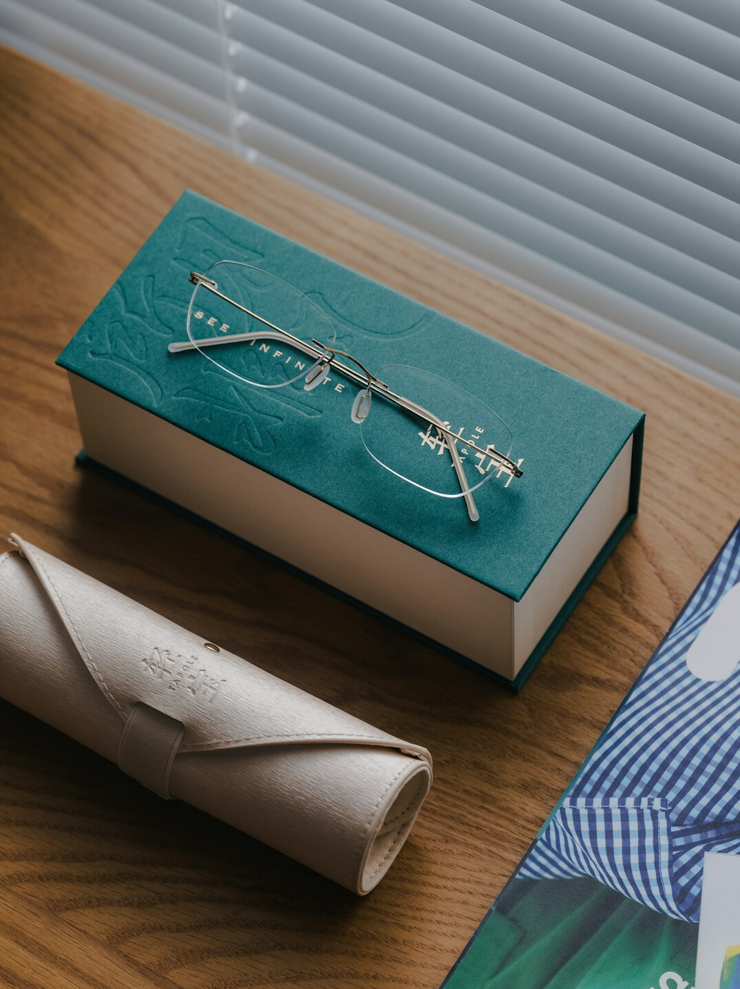 Folder with printed documents, pen and eyeglasses on a table